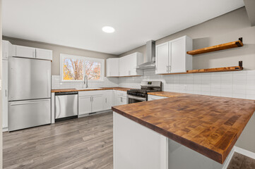 Wide View of Modern Kitchen with large window in front of kitchen sink, Bright Design