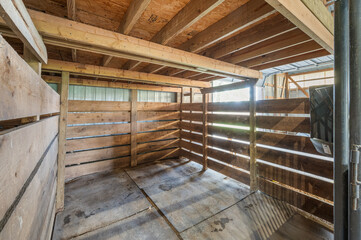 Indoor Wooden Horse Stall in Barn Setting