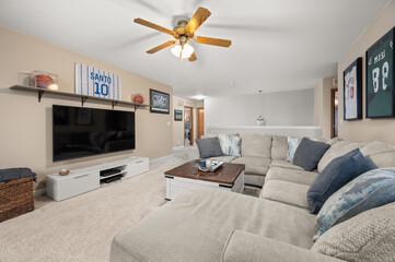 Cozy Living Room with Wall-Mounted TV and Comfortable Seating