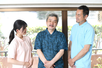 アジア人の介護士と高齢者の会話のイメージ