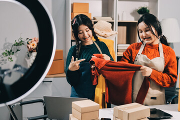 Portrait of Starting small businesses SME owners, two Asian woman check online orders Selling...