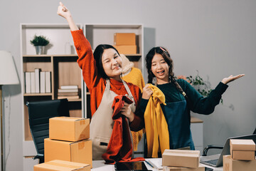 Portrait of Starting small businesses SME owners, two Asian woman check online orders Selling...