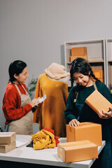 Portrait of Starting small businesses SME owners, two Asian woman check online orders Selling...