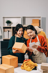 Portrait of Starting small businesses SME owners, two Asian woman check online orders Selling...