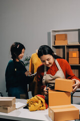 Portrait of Starting small businesses SME owners, two Asian woman check online orders Selling...
