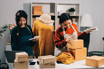 Portrait of Starting small businesses SME owners, two Asian woman check online orders Selling...