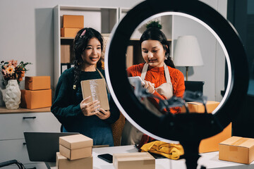 Portrait of Starting small businesses SME owners, two Asian woman check online orders Selling...