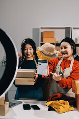 Portrait of Starting small businesses SME owners, two Asian woman check online orders Selling...