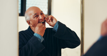 Dental health, mirror and senior man with flossing in bathroom for morning routine in home. Oral...