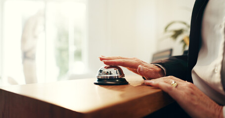 Person, hands and reception with service bell for request assistance or help in hotel. Closeup,...