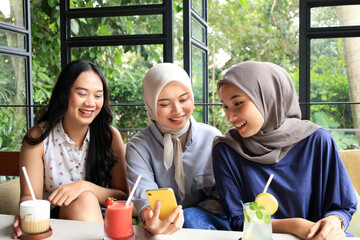 Group of Cheerful and Pretty Asian Female Friends Hanging Out at a Restaurant
