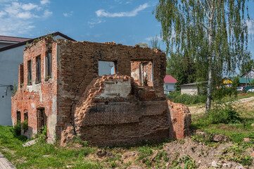 Abandoned ruins of a residential brick rural house.