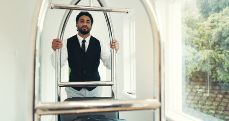 Porter, luggage and push trolley in hotel for suitcase handling, check in welcome or guest arrival....