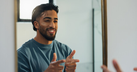Finger guns, mirror and man in bathroom with confidence for skincare, grooming and health in home....