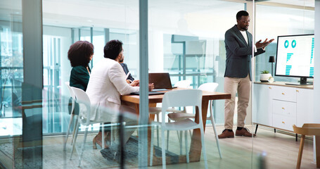 Businessman, presentation and team with charts, screen and point with stats, feedback or talk at...