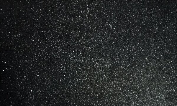 Abstract dust and scratch textures on a black background, with a grainy film effect and a vintage style.