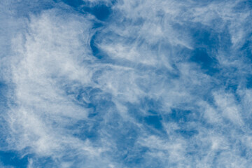 High cloud in the blue afternoon sky
