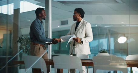 Fototapeta premium Business, handshake and men with documents, recruitment and onboarding with welcome. People, human resource manager and candidate in office, paperwork or shaking hands with review, hiring or contract