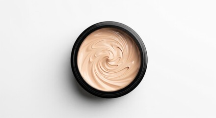 Bright Overhead View of Swirled Beige Liquid Foundation in a Black Jar on a Clean White Background.