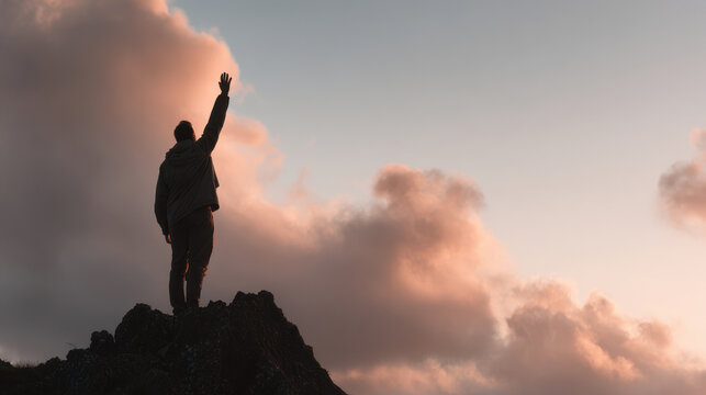 lone figure stands on rocky cliff at sunset raising hand in warning gesture
