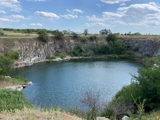 Unsurpassed view from above of a steppe lake created by nature in an abandoned stone quarry under...