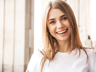 Portrait of beautiful smiling blond model dressed in summer hipster clothes. Trendy female posing...