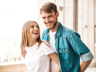 Portrait of smiling beautiful female and her handsome boyfriend. Woman in casual summer jeans...