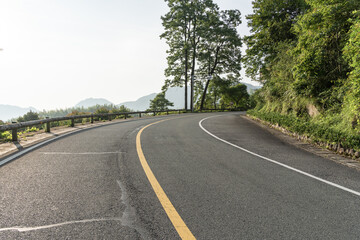 empty asphalt through mountain as background