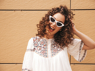 Beautiful smiling model with afro curls hairstyle dressed in summer hipster white dress. Sexy...