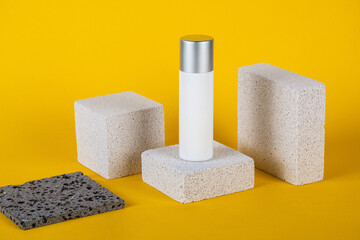 Plastic white tube for cream or lotion. Skin care or sunscreen cosmetic with stylish props on...