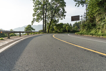 empty asphalt through mountain as background