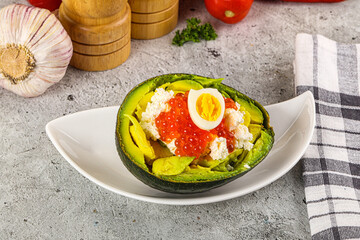 Avocado with red caviar and quil egg