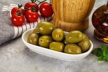Big green marinated olives in the bowl