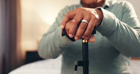 Senior hands, cane and recovery in home for injury, stroke or osteoporosis in bedroom for...