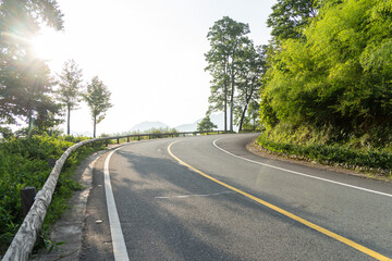 Fototapeta premium empty asphalt through mountain as background