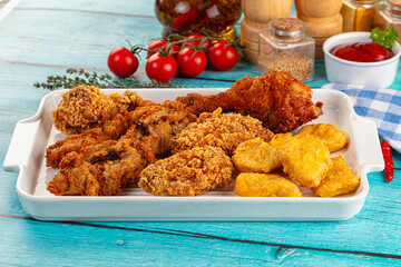 Golden crispy fried chicken mix - wings, drumsticks, nuggets and strips