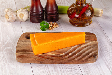 Yellow cheddae cheese over board
