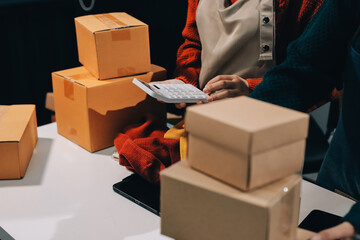 Portrait of Starting small businesses SME owners, two Asian woman check online orders Selling...