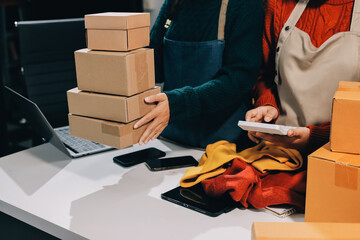 Portrait of Starting small businesses SME owners, two Asian woman check online orders Selling...