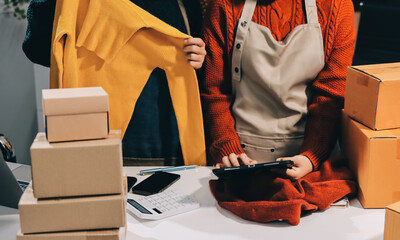 Portrait of Starting small businesses SME owners, two Asian woman check online orders Selling...
