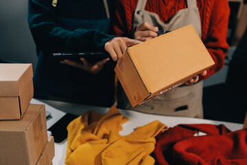 Portrait of Starting small businesses SME owners, two Asian woman check online orders Selling...