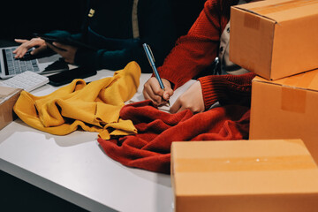 Portrait of Starting small businesses SME owners, two Asian woman check online orders Selling...
