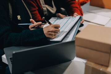 Portrait of Starting small businesses SME owners, two Asian woman check online orders Selling...