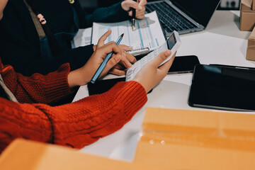 Portrait of Starting small businesses SME owners, two Asian woman check online orders Selling...