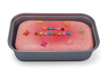 Happy Birthday message spelled with colorful beads on a pink cake concept.