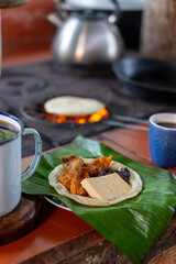 Costa Rican traditional tortilla with beans, cheese and pork by wood stove