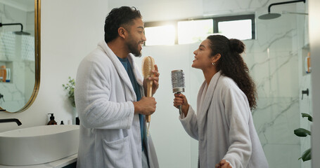 Fototapeta premium Couple, dance and singing in bathroom with love, energy and excited with morning routine. Brush, man and woman in home with music for celebration, karaoke rhythm and bonding with partner for romance