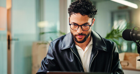 Reading, online and man in studio for podcast, broadcast and talk show at media agency. Radio...
