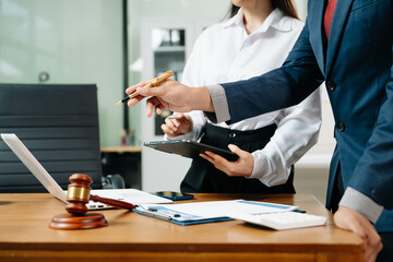 business people and lawyers discussing contract papers sitting at the table. Concepts of law,...