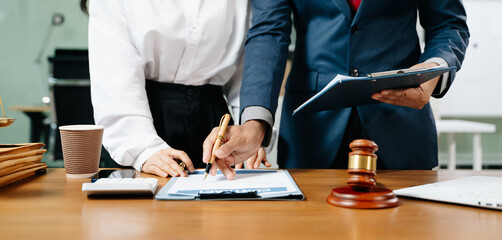 business people and lawyers discussing contract papers sitting at the table. Concepts of law,...